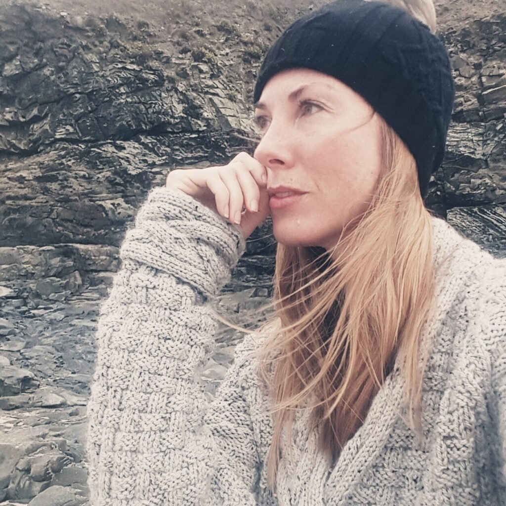 Counsellor Consett County Durham, Sarah Faulkner wearing a beanie, looking thoughtful